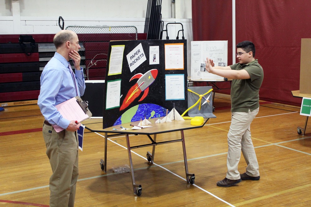 student demonstrates project to teacher