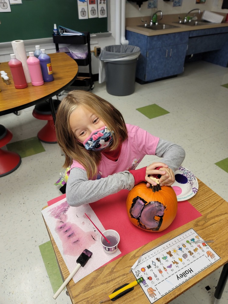 Girl painting pumpkin
