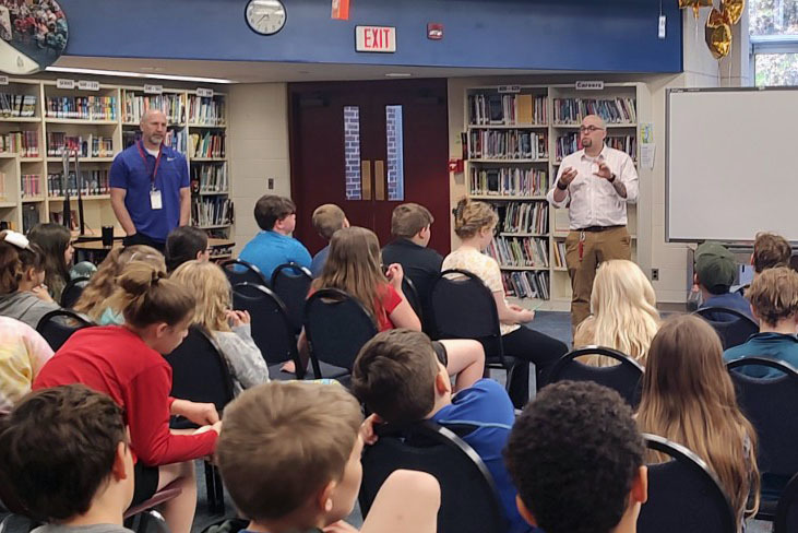 Mr. Stead and Mr. Fortran talk to audience of fifth graders