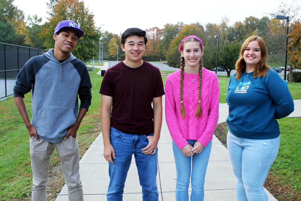 Two teenage boys and two teenage girls pose for photo