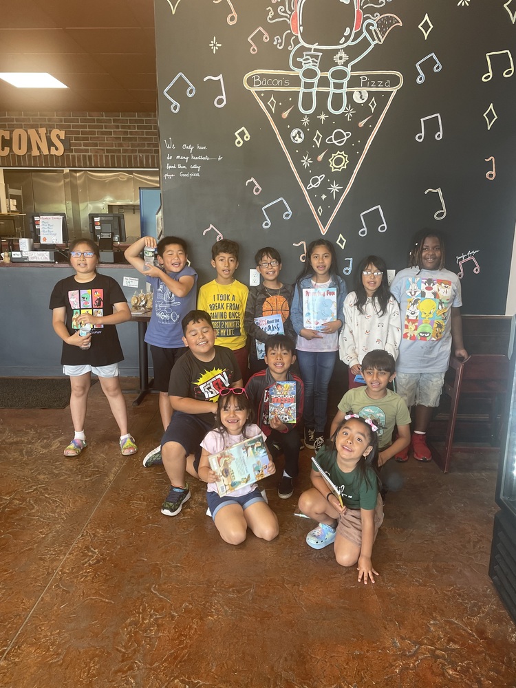 students pose for photo in restaurant 
