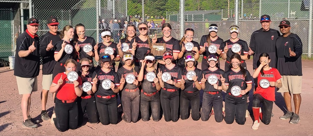 Softball team holding Section 2 championship plaques
