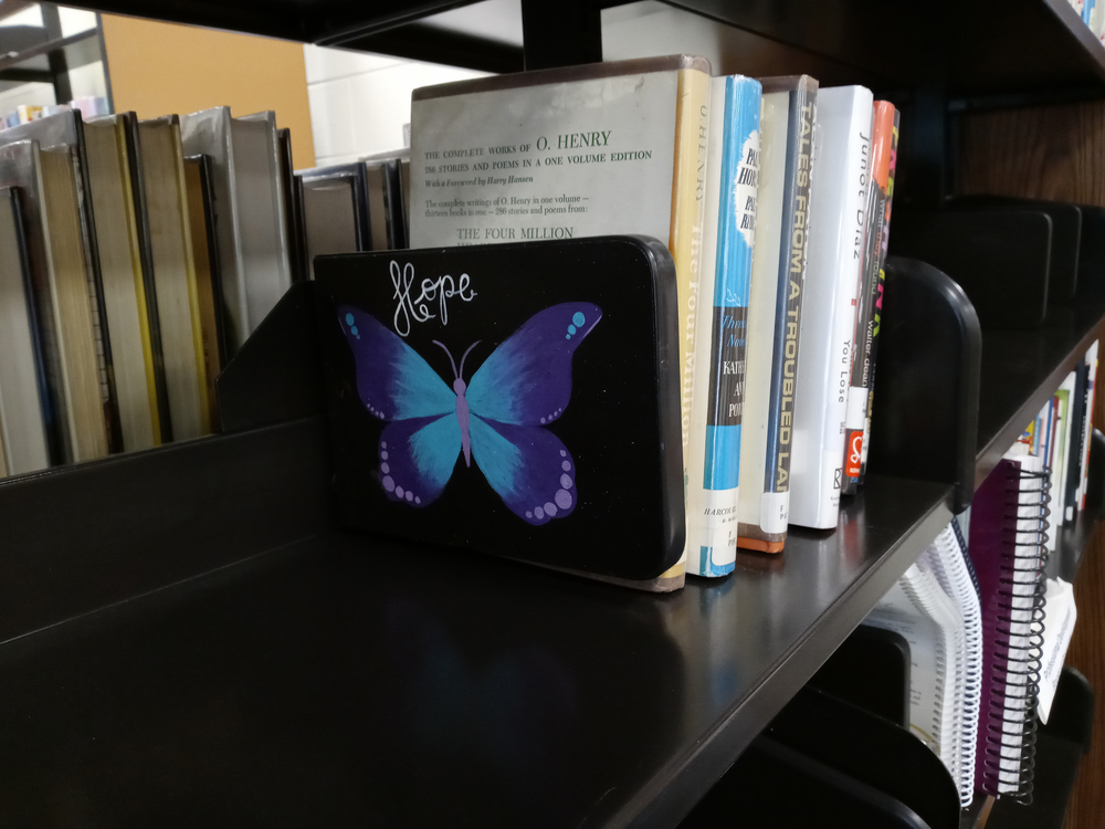 Library shelf with butterfly painted bookend