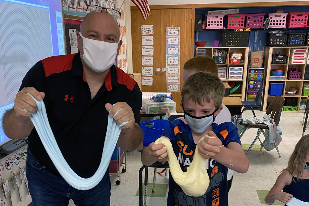 man and boy holding up slime