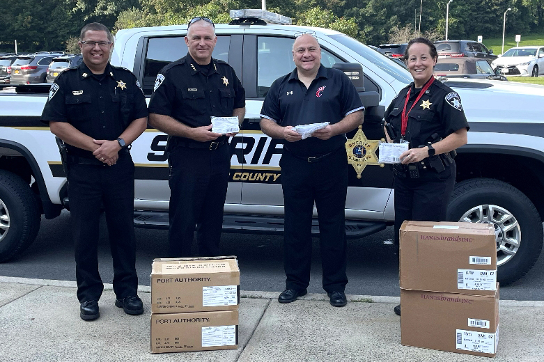Pictured with boxes of masks are (left to right) Deputy Louie Bray, Sheriff Dave Bartlett, Superintendent Sal DeAngelo, and Deputy Wendy Guntert