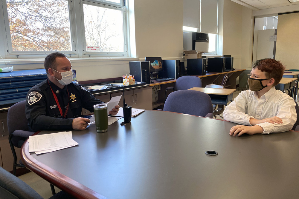 police officer interviewing student 