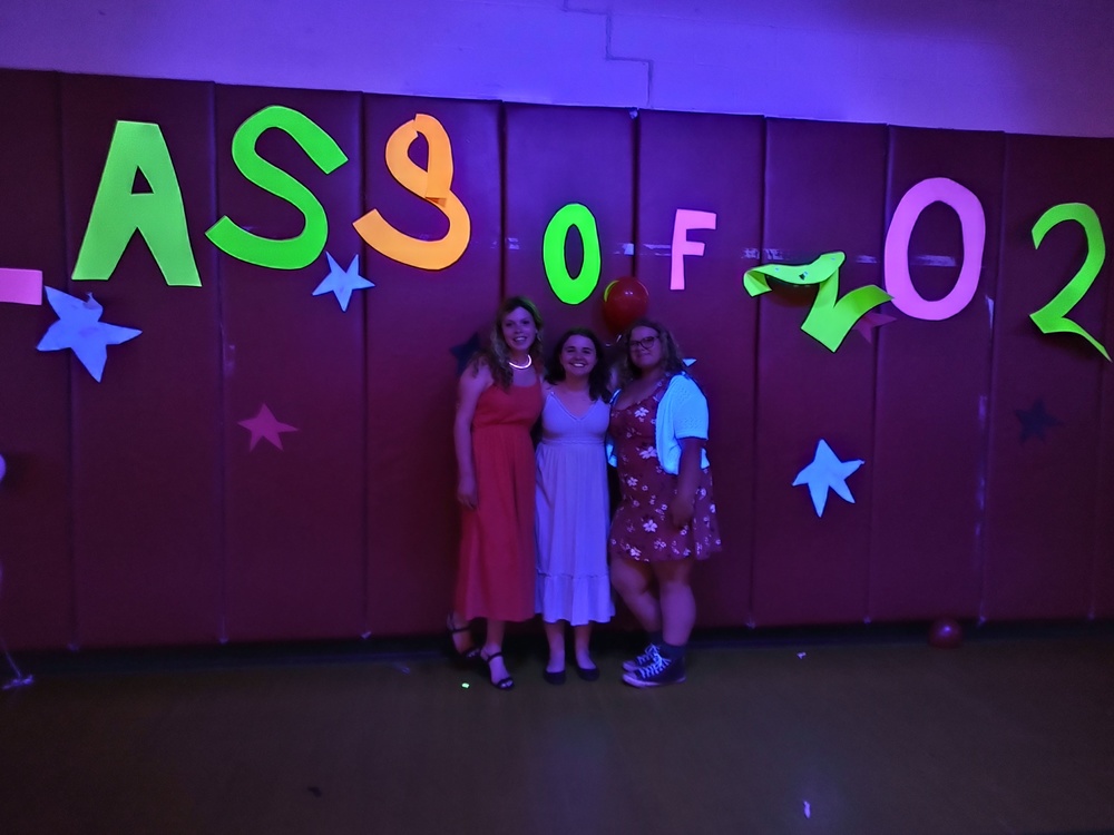 Three girls pose for photo at dance