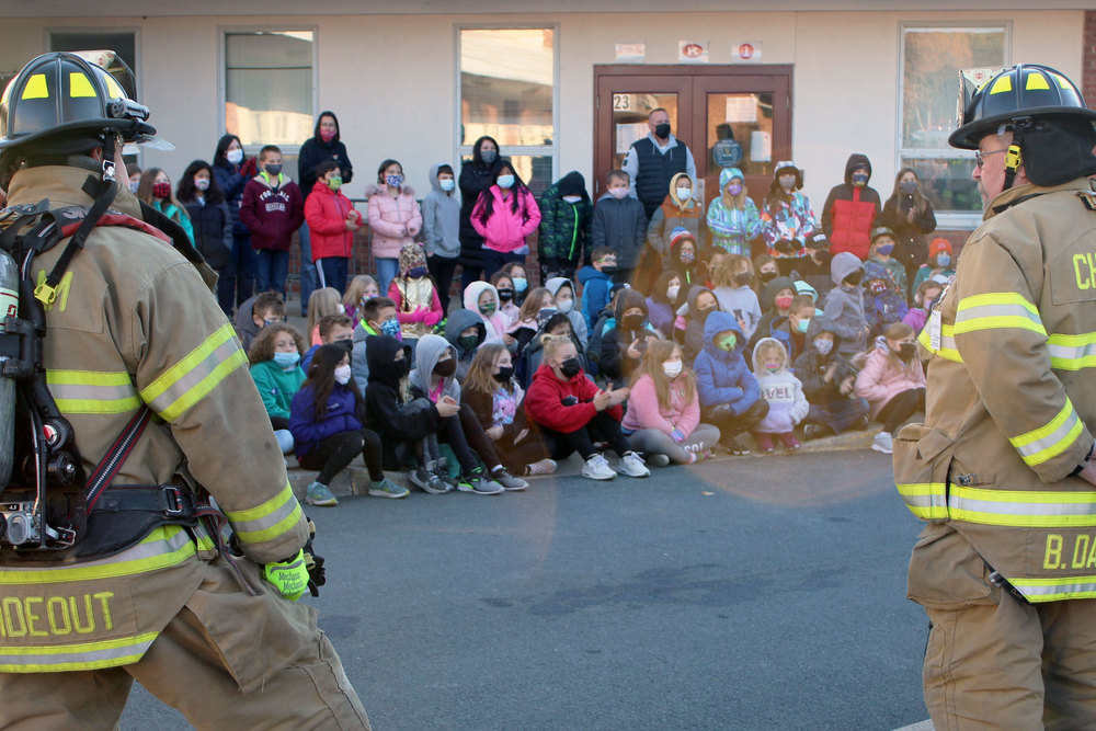firefighters and students outside school