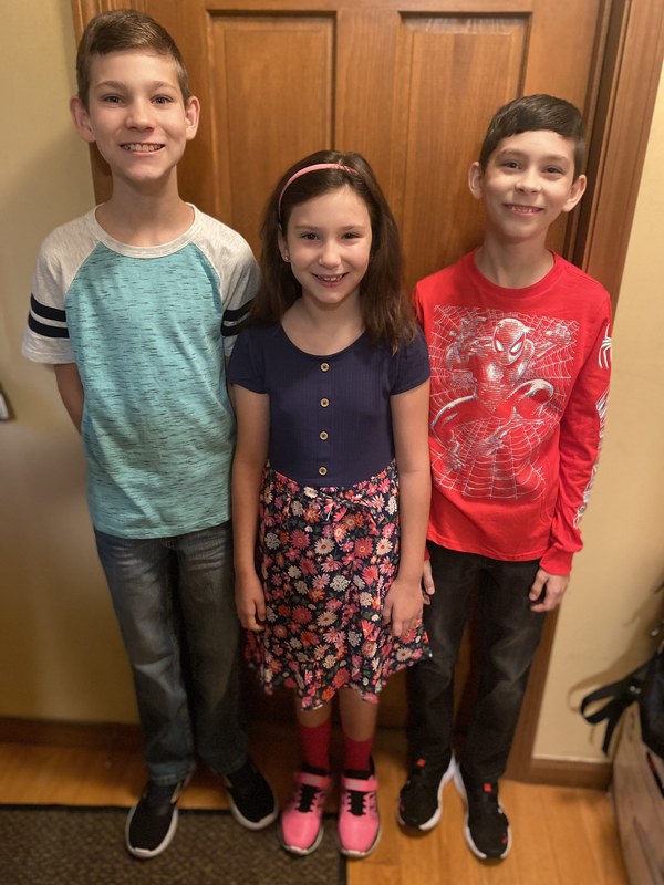 two boys and girl smiling 
