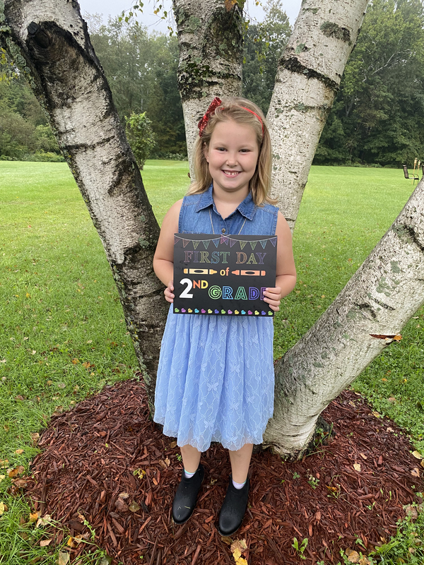 girl holding first day sign 