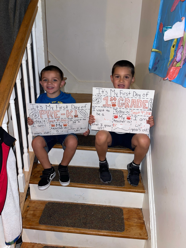 boy holding first day signs