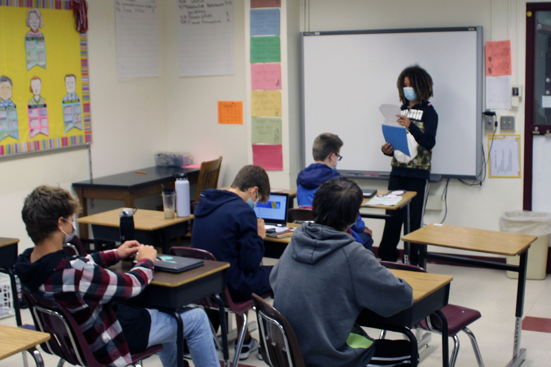 Boy giving report to class