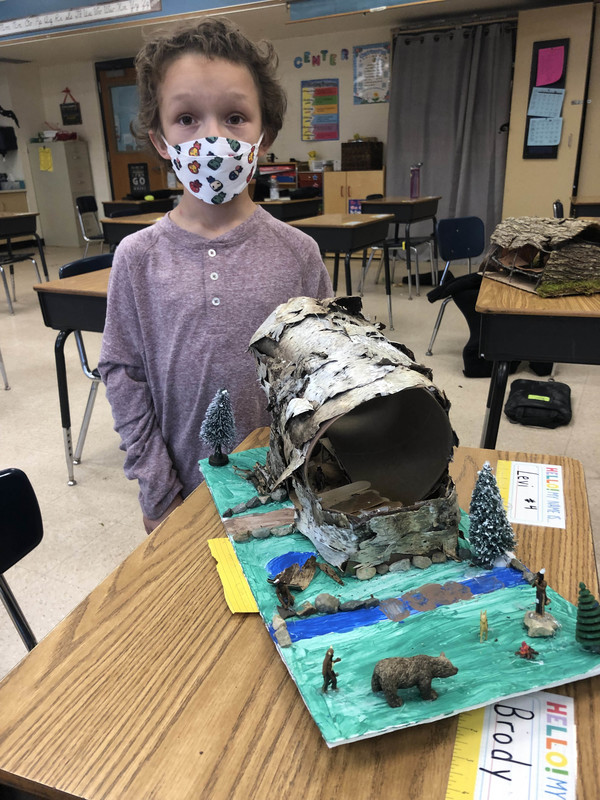 student with longhouse model