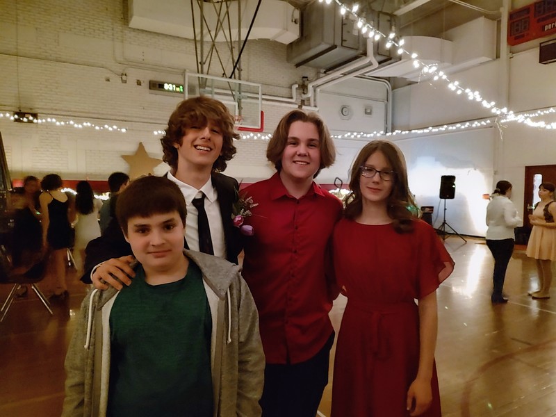 three boys and girl smiling