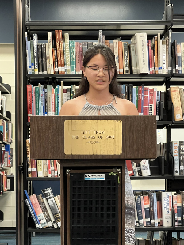 student reading at podium