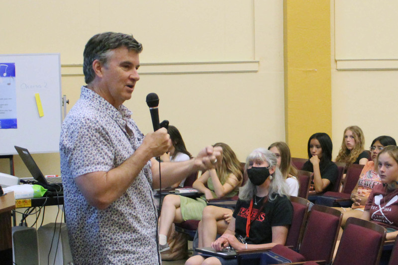 man talking to student audience in auditorium