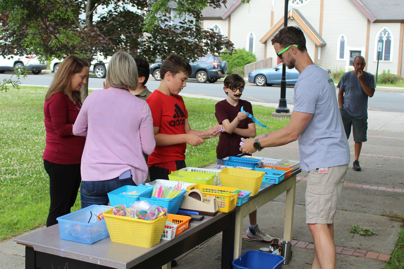 students redeeming tickets for prizes at prize table