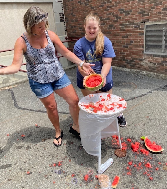 teacher and girls next to exploded watermelon