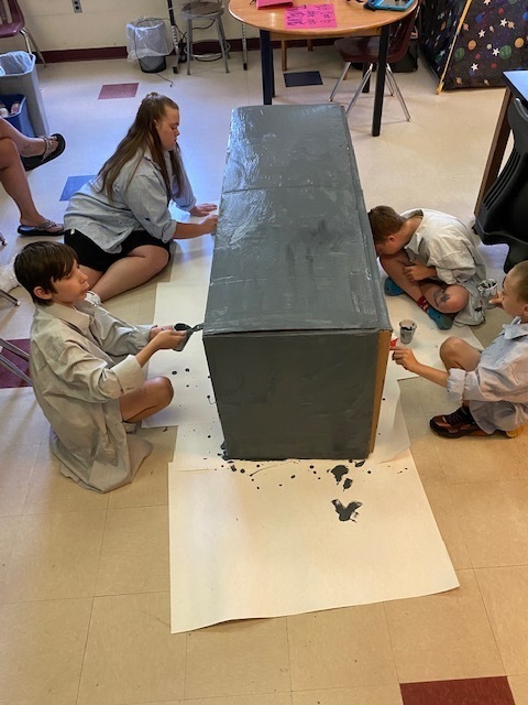 kids building shark out of cardboard box