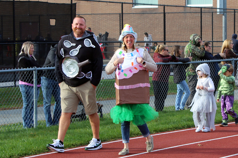 Dean of students and principal in costume head up the parade