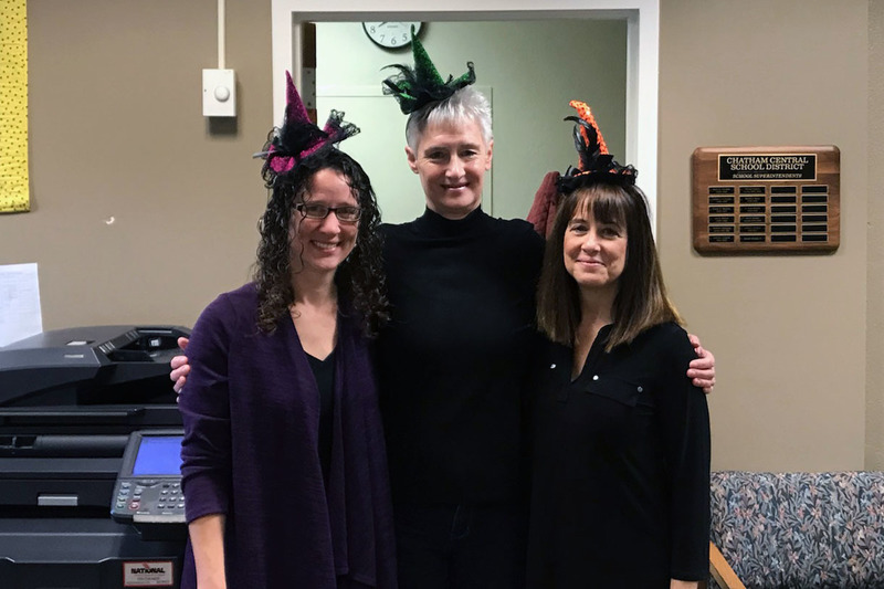 three women wearing tiny witch hats