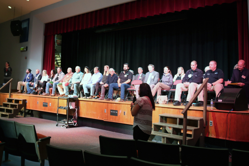 panel of community interviewers on the CHS auditorium stage