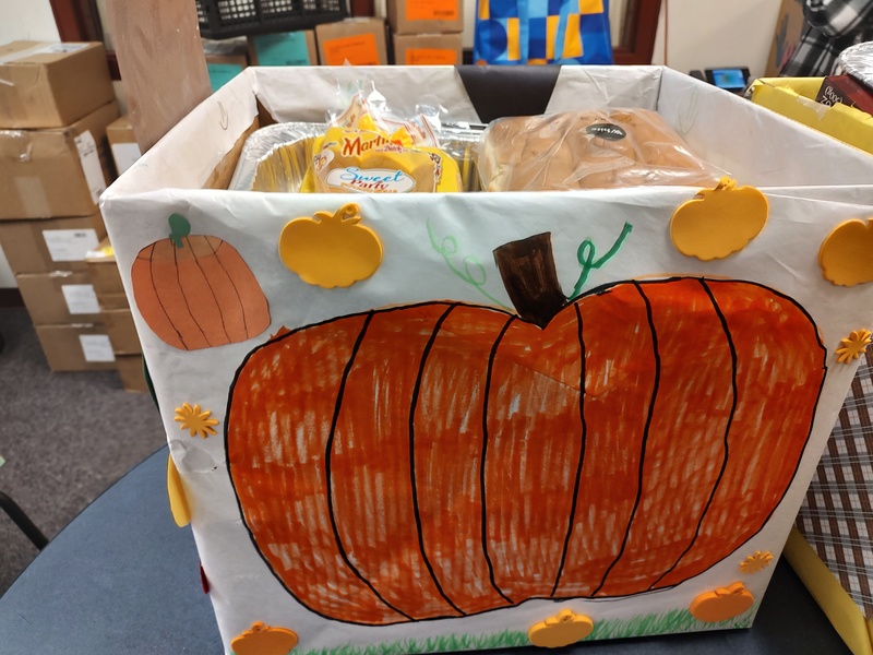 box decorated with pumpkin and filled with food