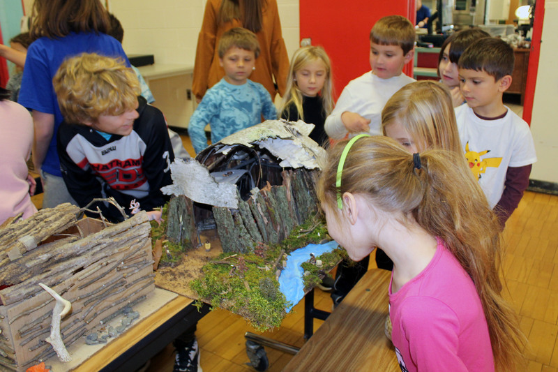 students look at longhouse model