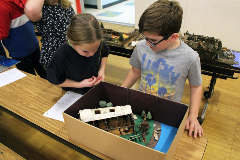 students look at longhouse model 