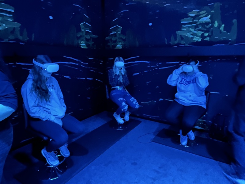 three girls wearing virtual reality headsets