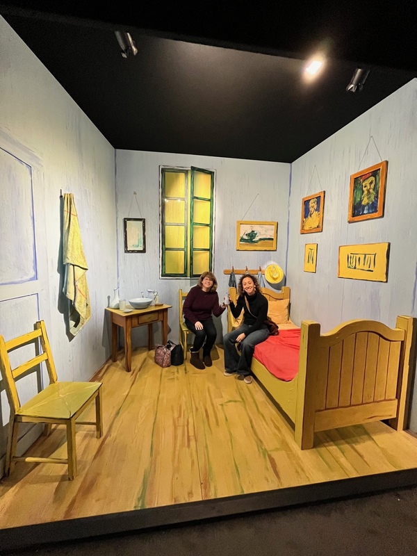 two women sitting in set that looks like Van Gogh painting