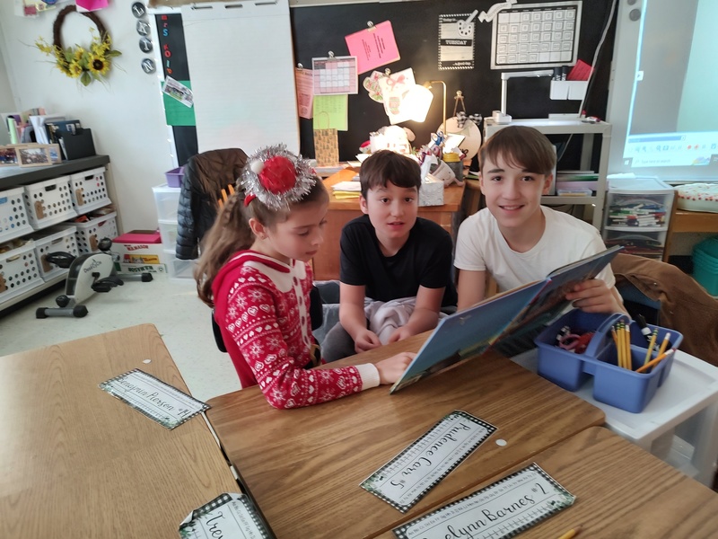 seventh and second grade students reading together