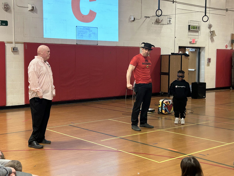 Rick Yarosh and Tom Murphy with student wearing lone ranger mask