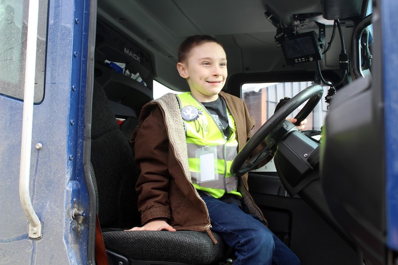 smiling boy sitting in truck cab