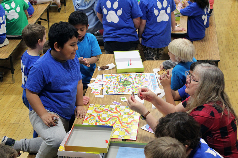 student and teacher playing board game