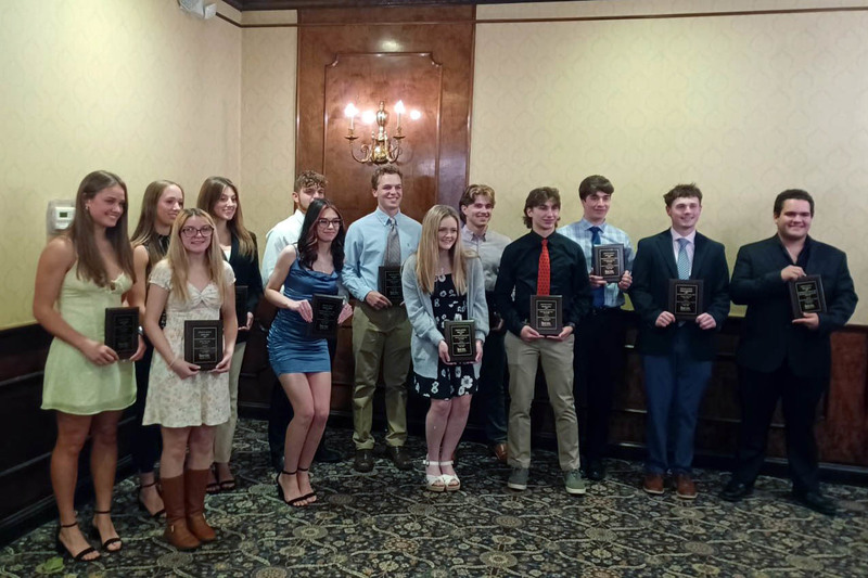 awardees pose with plaques