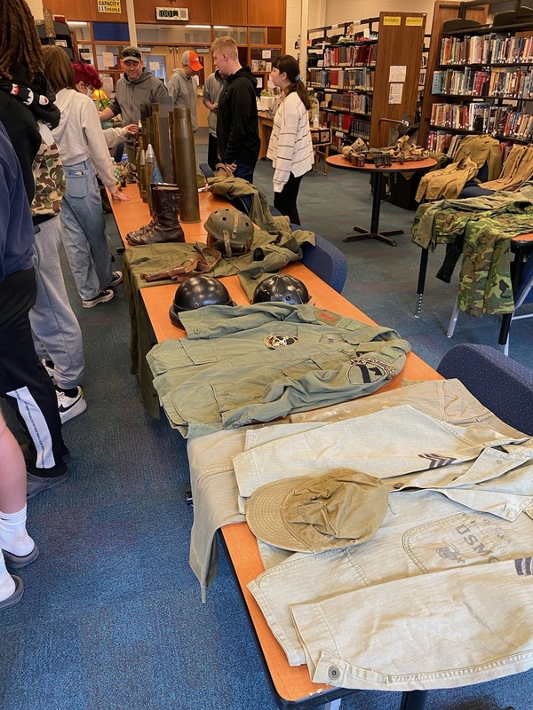 WWII military uniforms on table