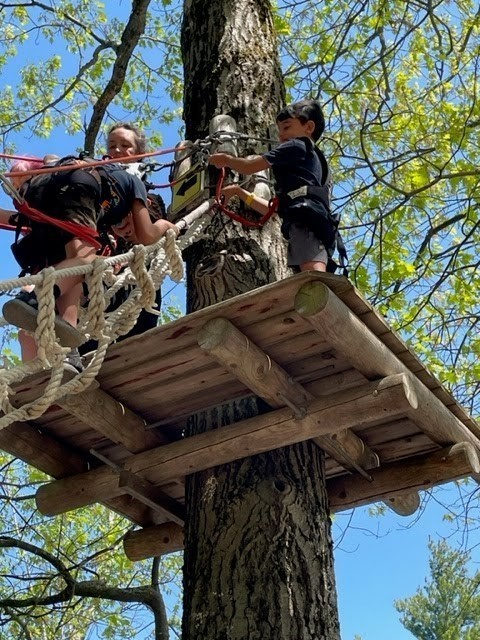 students on ropes course platform