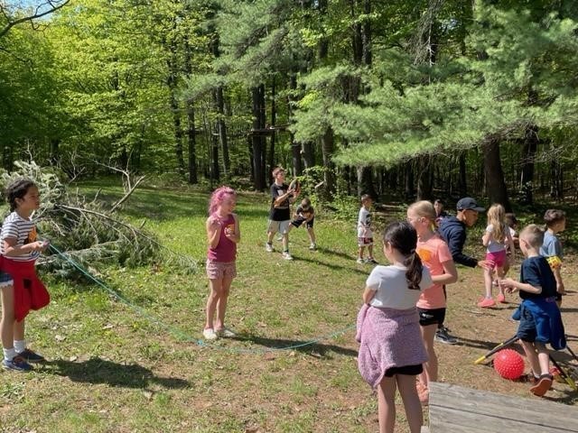 students playing in woods