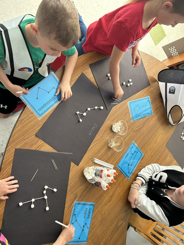 students making constellations with marshmallows and toothpicks 