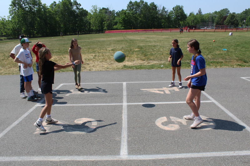 girls playing four-square
