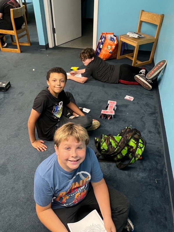 boys playing with cards on floor