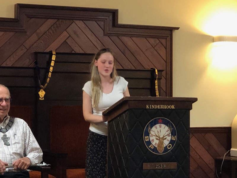 girl talks at podium in Elks Lodge