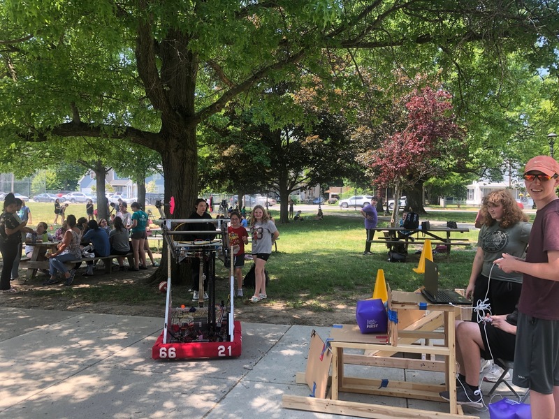 Robot on CMS playground surrounded by students