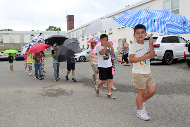 students walking with umbrellas overhead