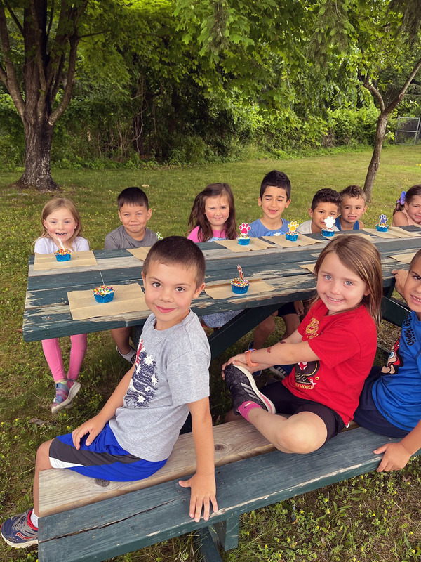 students sitting at picnic table