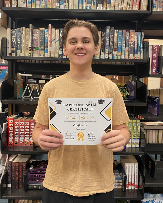 student holding certificate