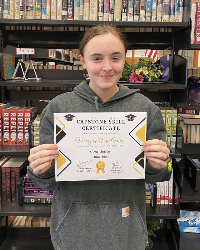 student holding certificate