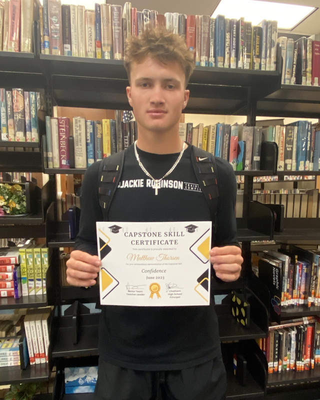 student holding certificate