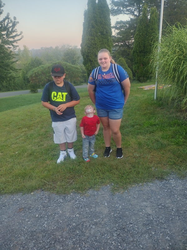 boy, girl, and toddler next to driveway